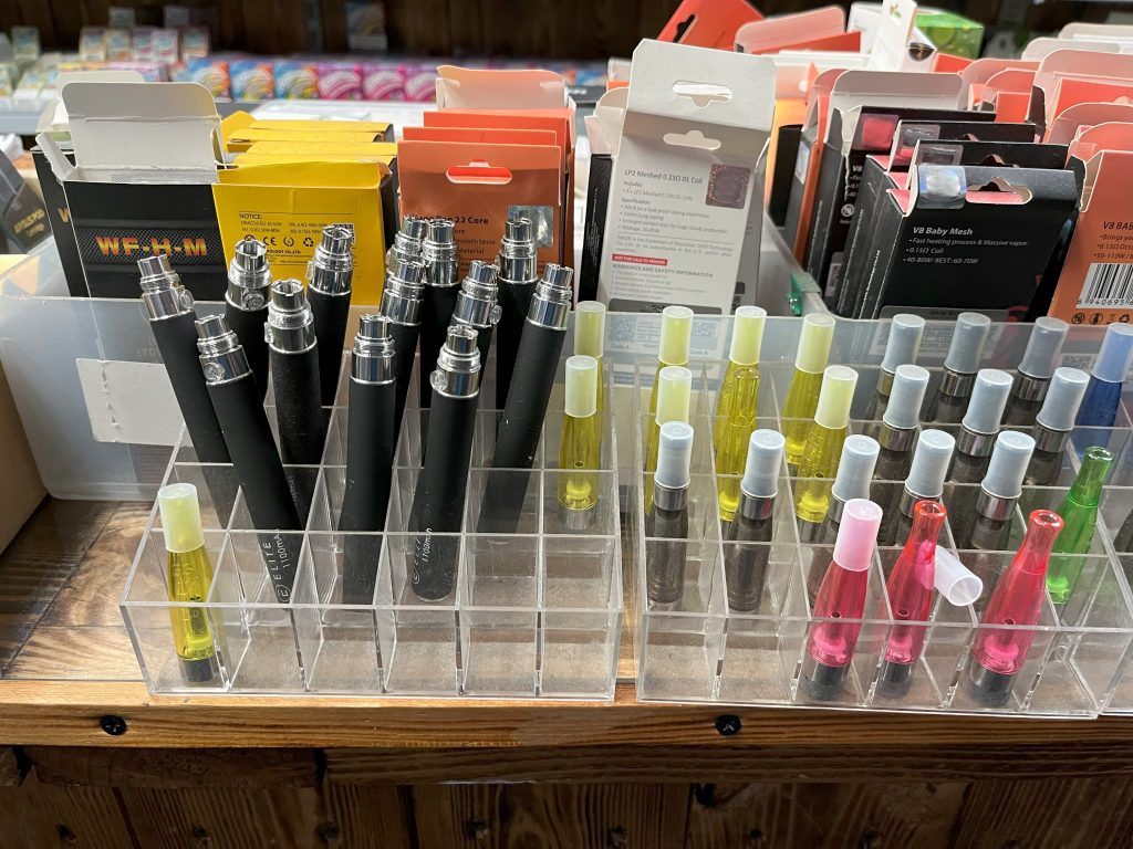 Older style vaping devices on a shop shelf